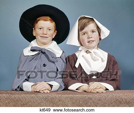 1950s 1960s BOY GIRL IN PILGRIM COSTUMES FOR ELEMENTARY SCHOOL THANKSGIVING PLAY LOOKING AT CAMERA View Large Photo Image Stock Photo - 1950s 1960s BOY GIRL IN PILGRIM COSTUMES FOR ELEMENTARY SCHOOL THANKSGIVING PLAY LOOKING AT CAMERA. Fotosearch