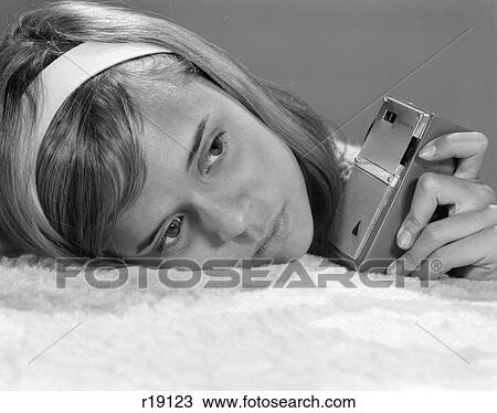 1950s 1960s CLOSE-UP OF TEENAGE GIRL WITH HEAD ON PILLOW LISTENING TO HAND-HELD TRANSISTOR RADIO View Large Photo Image Stock Image - 1950s 1960s CLOSE-UP OF TEENAGE GIRL WITH HEAD ON PILLOW LISTENING TO HAND-HELD TRANSISTOR RADIO. Fotosearch