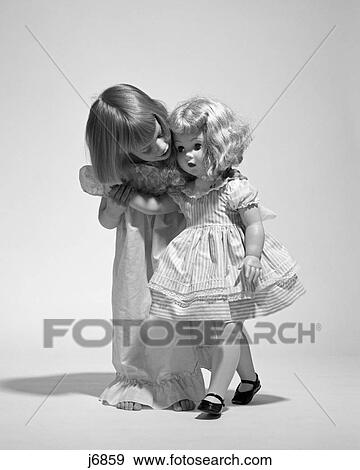 1950S 1960S Little Girl Whispering To Her Life-Size Walking Blonde Baby Doll Toy View Large Photo Image Stock Photo - 1950S 1960S Little Girl Whispering To Her Life-Size Walking Blonde Baby Doll Toy . Fotosearch