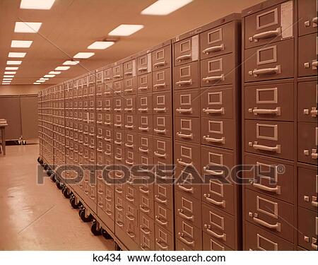 Picture - 1950s 1960s LONG ROW OF GREEN GRAY METAL FILE CABINETS ON CASTERS DATA STORAGE SYSTEM ORGANIZATION. Fotosearch