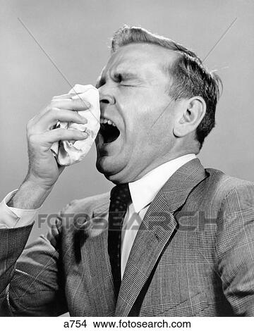 Picture - 1950s 1960s MAN SNEEZING INTO HANDKERCHIEF. Fotosearch