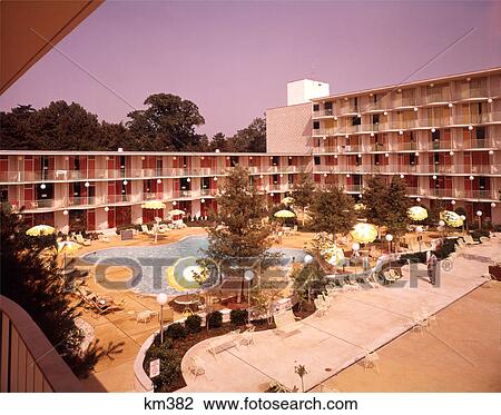 1950s 1960s MOTEL BUILDING BALCONIES OVERLOOKING SWIMMING POOL YELLOW UMBRELLAS View Large Photo Image Stock Image - 1950s 1960s MOTEL BUILDING BALCONIES OVERLOOKING SWIMMING POOL YELLOW UMBRELLAS. Fotosearch