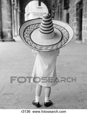 1950S 1960S Small Girl Tourist Seen From Behind Wearing Oversized Too Big Straw Hat View Large Photo Image Stock Photograph - 1950S 1960S Small Girl Tourist Seen From Behind Wearing Oversized Too Big Straw Hat. Fotosearch