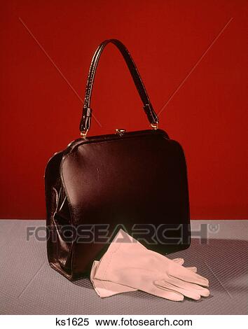 1950s 1960s STILL LIFE LADIES BLACK HANDBAG PAIR WHITE GLOVES FASHION ACCESSORIES View Large Photo Image Stock Photography - 1950s 1960s STILL LIFE LADIES BLACK HANDBAG PAIR WHITE GLOVES FASHION ACCESSORIES. Fotosearch