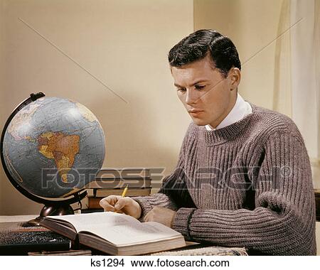 1950s 1960s TEENAGE BOY STUDENT STUDYING AT DESK WITH GLOBE OPEN TEXTBOOKS COLLEGE AGE View Large Photo Image Picture - 1950s 1960s TEENAGE BOY STUDENT STUDYING AT DESK WITH GLOBE OPEN TEXTBOOKS COLLEGE AGE. Fotosearch