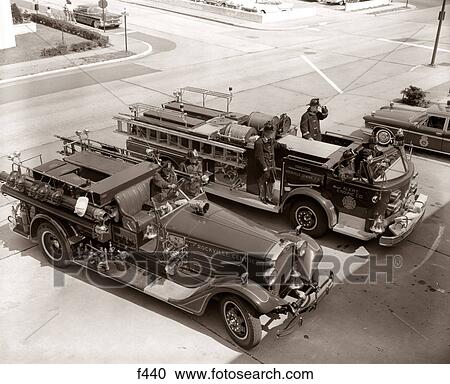 1950s 1960s TOP VIEW OF TWO FIRE TRUCKS PARKED AT STATION FIREMEN ON TRUCK WEARING PROTECTIVE EQUIPMENT View Large Photo Image Stock Image - 1950s 1960s TOP VIEW OF TWO FIRE TRUCKS PARKED AT STATION FIREMEN ON TRUCK WEARING PROTECTIVE EQUIPMENT. Fotosearch