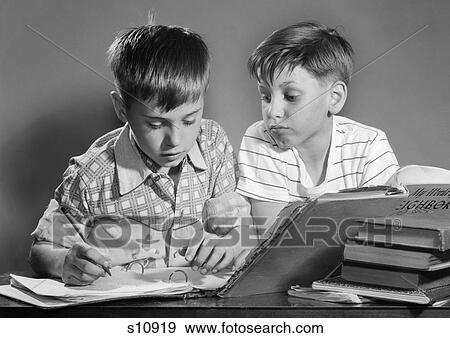 1950s 1960s TWO BOYS WITH SCHOOLBOOKS AND PAPERS STUDYING TOGETHER INDOOR View Large Photo Image Stock Photo - 1950s 1960s TWO BOYS WITH SCHOOLBOOKS AND PAPERS STUDYING TOGETHER INDOOR. Fotosearch