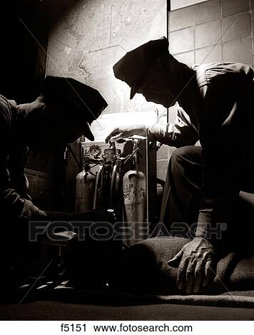 1950s 1960s TWO LIFESAVING EMT FIREMEN RESCUE WORKERS EMERGENCY MEDICAL PERSONNEL USING RESUSCITATOR ON CHILD VICTIM View Large Photo Image Stock Image - 1950s 1960s TWO LIFESAVING EMT FIREMEN RESCUE WORKERS EMERGENCY MEDICAL PERSONNEL USING RESUSCITATOR ON CHILD VICTIM. Fotosearch