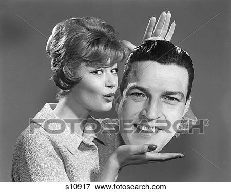 1950S 1960S Woman Holding Life-Size Photo Picture Of Man’S Head In Her Hands Puckering Lips To Kiss View Large Photo Image Stock Photo - 1950S 1960S Woman Holding Life-Size Photo Picture Of Man’S Head In Her Hands Puckering Lips To Kiss . Fotosearch