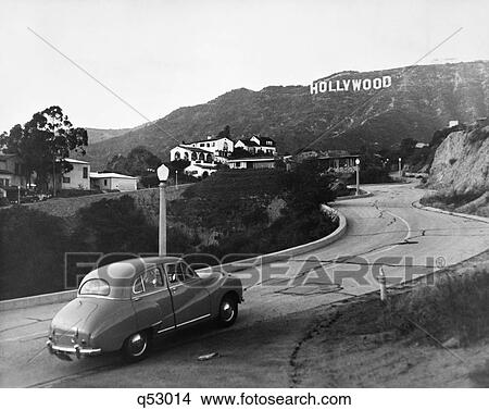 1950S Austin Car Driving Up The Hollywood Hills With Hollywood Sign In Distance View Large Photo Image Picture - 1950S Austin Car Driving Up The Hollywood Hills With Hollywood Sign In Distance. Fotosearch