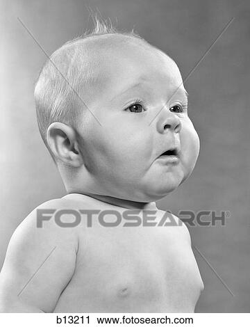 Stock Image - 1950s BABY IN PROFILE WITH POMPOUS FACIAL EXPRESSION. Fotosearch