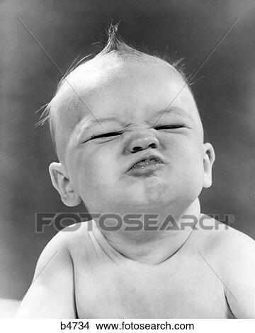 1950s BABY SCRUNCHING UP FACE SQUINTING View Large Photo Image Picture - 1950s BABY SCRUNCHING UP FACE SQUINTING. Fotosearch
