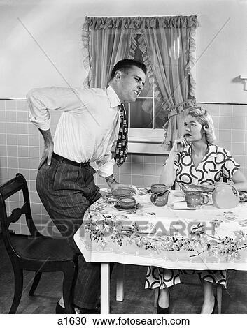 1950S Couple At Breakfast Table Man With Hand On Hip Suffering Back Pain View Large Photo Image Stock Image - 1950S Couple At Breakfast Table Man With Hand On Hip Suffering Back Pain. Fotosearch