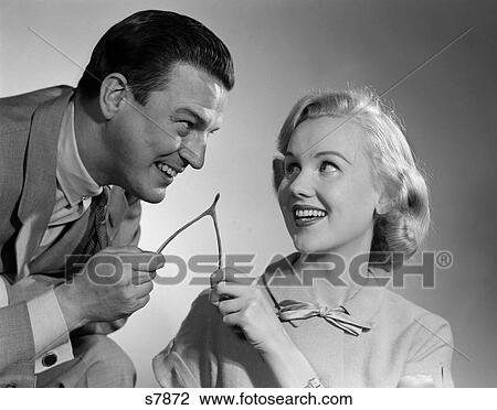 1950s COUPLE PULLING AND BREAKING A WISHBONE FOR LUCK TRADITION View Large Photo Image Stock Image - 1950s COUPLE PULLING AND BREAKING A WISHBONE FOR LUCK TRADITION. Fotosearch