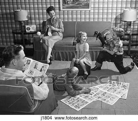 1950S Family 5 Living Room Kids On Floor Reading Comics Playing With Dog Mother Knitting Father Reading Newspaper View Large Photo Image Picture - 1950S Family 5 Living Room Kids On Floor Reading Comics Playing With Dog Mother Knitting Father Reading Newspaper. Fotosearch