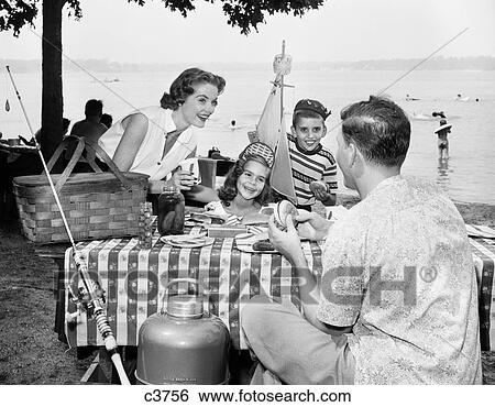 1950s FAMILY MOTHER FATHER BOY GIRL EATING PICNIC LAKESIDE PICNIC TABLE View Large Photo Image Stock Photograph - 1950s FAMILY MOTHER FATHER BOY GIRL EATING PICNIC LAKESIDE PICNIC TABLE. Fotosearch