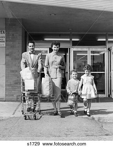 1950s FAMILY OF FOUR WALKING OUT OF GROCERY STORE FATHER PUSHING SHOPPING CART MOTHER AND SON CARRYING BAGS View Large Photo Image Stock Photo - 1950s FAMILY OF FOUR WALKING OUT OF GROCERY STORE FATHER PUSHING SHOPPING CART MOTHER AND SON CARRYING BAGS. Fotosearch
