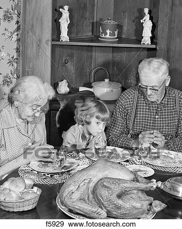 1950S Family Thanksgiving Dinner Praying Girl And Grandparents View Large Photo Image Stock Photo - 1950S Family Thanksgiving Dinner Praying Girl And Grandparents. Fotosearch