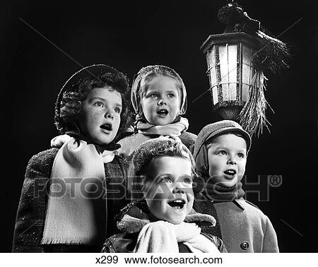 1950S Four Young Children Singing Christmas Carols Outdoor By Lantern Light View Large Photo Image Stock Photo - 1950S Four Young Children Singing Christmas Carols Outdoor By Lantern Light. Fotosearch