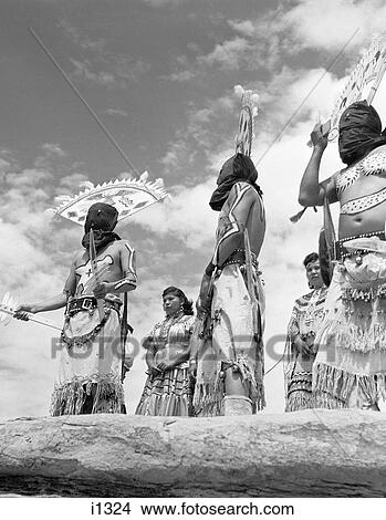 Picture - 1950s GROUP OF NATIVE AMERICAN APACHE INDIANS PERFORMING APACHE DEVIL DANCE SOUTHWEST USA. Fotosearch
