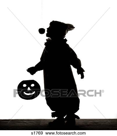1950s HALLOWEEN SILHOUETTED CHILD IN COSTUME JACK-O-LANTERN CANDIED APPLE ON STRING View Large Photo Image Stock Photo - 1950s HALLOWEEN SILHOUETTED CHILD IN COSTUME JACK-O-LANTERN CANDIED APPLE ON STRING. Fotosearch