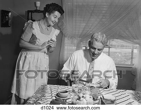 Picture - 1950S Husband Eating Dinner As Wife Looks On. Fotosearch