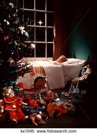 1950s LITTLE GIRL SLEEPING BED STAR SKY WINDOW CHRISTMAS TREE PRESENTS TOYS FOREGROUND CHRISTMAS EVE HOLIDAY View Large Photo Image Stock Photography - 1950s LITTLE GIRL SLEEPING BED STAR SKY WINDOW CHRISTMAS TREE PRESENTS TOYS FOREGROUND CHRISTMAS EVE HOLIDAY. Fotosearch