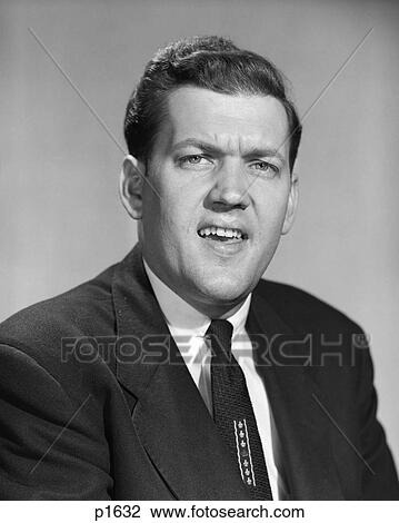 1950s MAN BUSINESS IN SUIT AND TIE MAKING SKEPTICAL FUNNY FACE EXPRESSION LOOKING AT CAMERA View Large Photo Image Stock Image - 1950s MAN BUSINESS IN SUIT AND TIE MAKING SKEPTICAL FUNNY FACE EXPRESSION LOOKING AT CAMERA. Fotosearch