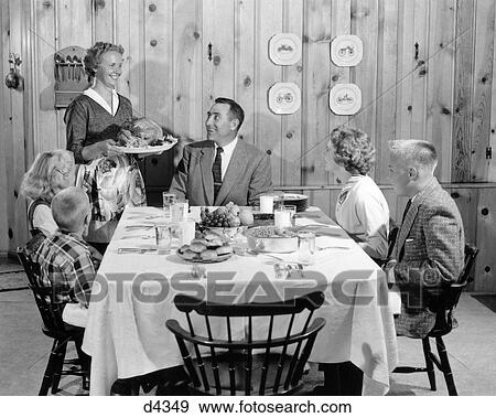 1950s MOTHER SERVING TURKEY ON PLATTER TO SMILING FAMILY AT TABLE IN KNOTTY PINE PANELED DINING ROOM View Large Photo Image Stock Photo - 1950s MOTHER SERVING TURKEY ON PLATTER TO SMILING FAMILY AT TABLE IN KNOTTY PINE PANELED DINING ROOM. Fotosearch
