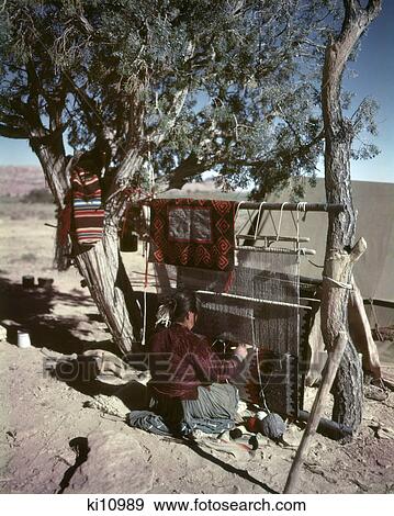 Stock Photo - 1950s NAVAJO NATIVE AMERICAN WOMAN AT LOOM WEAVING BLANKET CAMERON ARIZONA USA. Fotosearch