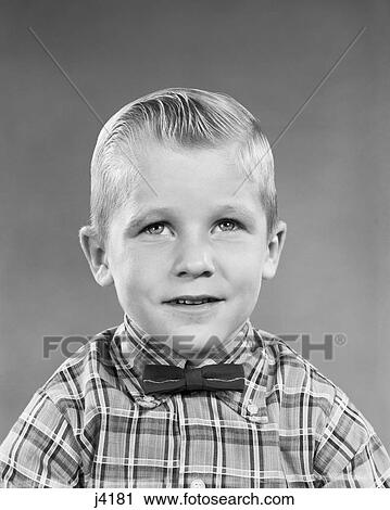 Stock Image - 1950S Portrait Blond Boy Slick Hair Wearing Plaid Shirt Bow Tie . Fotosearch