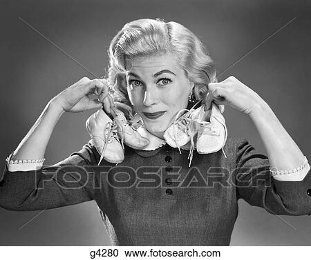 1950S Portrait Blond Woman Holding Up A Pair Of Baby Booties In Each Hand Looking At Camera View Large Photo Image Stock Image - 1950S Portrait Blond Woman Holding Up A Pair Of Baby Booties In Each Hand Looking At Camera. Fotosearch