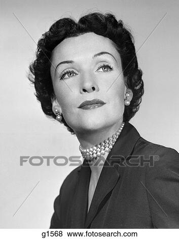 1950s PORTRAIT SOPHISTICATED MIDDLE AGED BRUNETTE WOMAN WEARING PEARL NECKLACE EARRINGS FASHION BEAUTY View Large Photo Image Stock Photo - 1950s PORTRAIT SOPHISTICATED MIDDLE AGED BRUNETTE WOMAN WEARING PEARL NECKLACE EARRINGS FASHION BEAUTY. Fotosearch