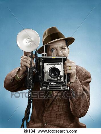 Picture - 1950S Press Photographer Man Holding A 4X5 Speed Graphic Camera With Portable Strobe Flash. Fotosearch