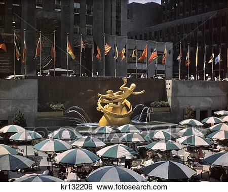 Stock Photograph - 1950S Prometheus Fountain Umbrellas Of Garden Restaurant Midtown Manhattan Rockefeller Center Nyc Usa. Fotosearch