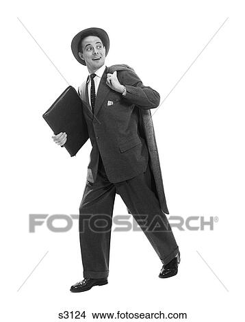 Picture - 1950S Salesman Businessman Briefcase Hat Walking Coat Over Shoulder Smiling Expression Looking Back Over Shoulder At Competition. Fotosearch