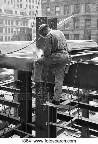 1950S Side View Of Construction Worker Welding On Steel Girder Frame Of Building Under Construction View Large Photo Image Picture - 1950S Side View Of Construction Worker Welding On Steel Girder Frame Of Building Under Construction. Fotosearch