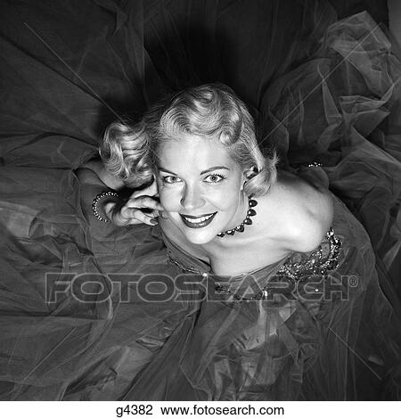 1950s SMILING BLOND WOMAN LOOKING UP FORMAL STRAPLESS EVENING GOWN GLAMOROUS View Large Photo Image Stock Image - 1950s SMILING BLOND WOMAN LOOKING UP FORMAL STRAPLESS EVENING GOWN GLAMOROUS. Fotosearch