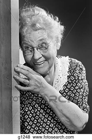 1950S Smiling Elderly Woman Peeking Around Door Eavesdropping View Large Photo Image Stock Photo - 1950S Smiling Elderly Woman Peeking Around Door Eavesdropping. Fotosearch