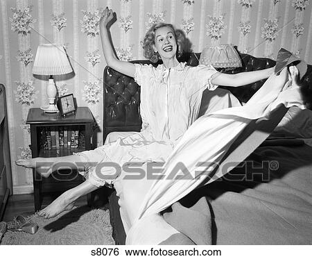 1950S Smiling Happy Gleeful Woman Waking Up Getting Out Of Bed Flinging Back Sheets And Blankets View Large Photo Image Stock Photograph - 1950S Smiling Happy Gleeful Woman Waking Up Getting Out Of Bed Flinging Back Sheets And Blankets. Fotosearch
