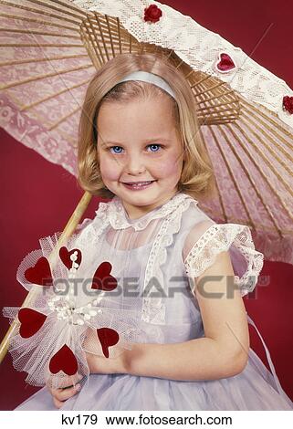 1950s SMILING LITTLE BLOND GIRL LOOKING AT CAMERA WITH VALENTINE BOUQUET OF RED HEARTS AND FLOWERS UNDER LACY PARASOL UMBRELLA View Large Photo Image Stock Photo - 1950s SMILING LITTLE BLOND GIRL LOOKING AT CAMERA WITH VALENTINE BOUQUET OF RED HEARTS AND FLOWERS UNDER LACY PARASOL UMBRELLA. Fotosearch