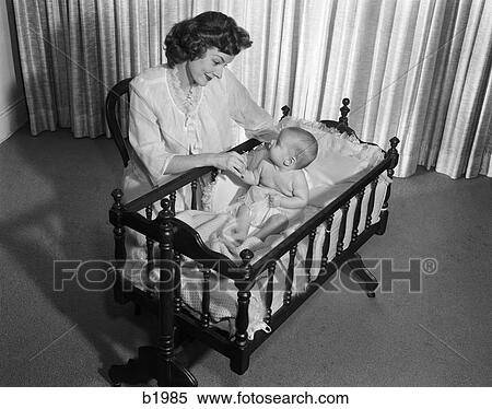 1950S Smiling Woman Mother Kneeling By Crib With Baby View Large Photo Image Stock Photography - 1950S Smiling Woman Mother Kneeling By Crib With Baby. Fotosearch