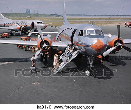 1950s TWO AMERICAN AIRLINE PROPELLER AIRPLANES ON TARMAC WITH PASSENGERS CLIMBING ABOARD LAGUARDIA AIRPORT NEW YORK USA View Large Photo Image Stock Image - 1950s TWO AMERICAN AIRLINE PROPELLER AIRPLANES ON TARMAC WITH PASSENGERS CLIMBING ABOARD LAGUARDIA AIRPORT NEW YORK USA. Fotosearch