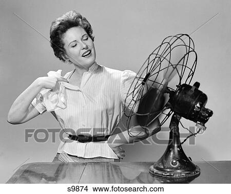 Picture - 1950S Woman Cooling With Swivel Fan. Fotosearch