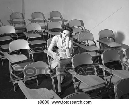1950S Woman Sitting In Classroom Of Empty Chairs Annoyed View Large Photo Image Stock Image - 1950S Woman Sitting In Classroom Of Empty Chairs Annoyed. Fotosearch