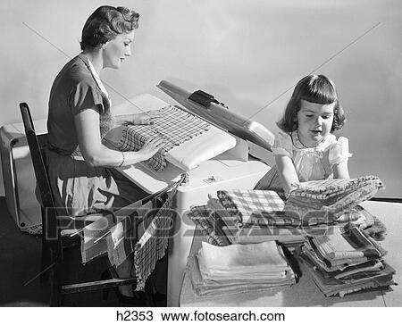 1950Shousewife Pressing Linens As Daughter Folds & Stacks Them On Table View Large Photo Image Stock Image - 1950Shousewife Pressing Linens As Daughter Folds & Stacks Them On Table. Fotosearch
