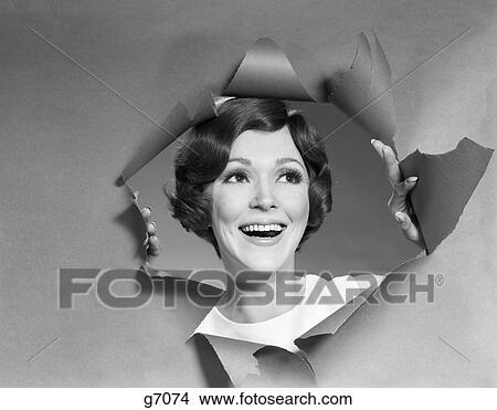 1960s 1960s WOMAN SMILING LOOKING BREAKING THROUGH TORN PAPER View Large Photo Image Picture - 1960s 1960s WOMAN SMILING LOOKING BREAKING THROUGH TORN PAPER. Fotosearch