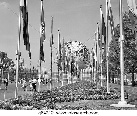 Stock Image - 1960s 1964 UNISPHERE WITH INTERNATIONAL FLAGS NEW YORK WORLD'S FAIR FLUSHING MEADOW PARK NY USA. Fotosearch