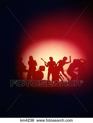 Stock Photo - 1960S 1970S Anonymous Silhouetted Rock Band Circle Of Light Musicians Performers Music Dance. Fotosearch