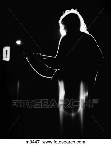 1960s 1970s ANONYMOUS SILHOUETTED ROCK MUSICIAN PLAYING GUITAR MOODY BACKLIT ON STAGE View Large Photo Image Stock Photo - 1960s 1970s ANONYMOUS SILHOUETTED ROCK MUSICIAN PLAYING GUITAR MOODY BACKLIT ON STAGE. Fotosearch